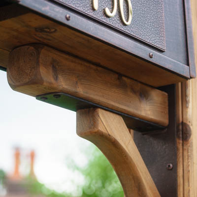 black steel mailbox bracket with cedar trim