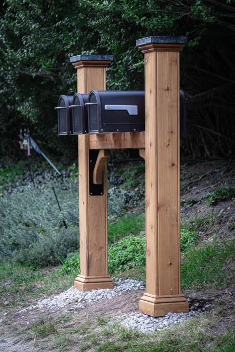 cedar group mail box post with granite post caps, and a cross member to hold boxes